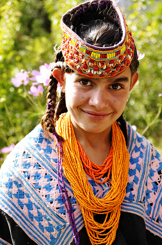 Kalasha girl with headdress and beaded necklace Kalasha girl with headdress and beaded necklace